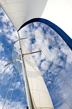 The sail of the yacht on blue sky background