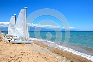 Sail yachts on the beach on Ionian Sea at luxury hotel