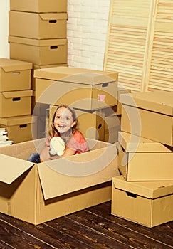 Sail Into Your New Home. happy child cardboard box. Moving concept. new apartment. happy little girl with toy. Cardboard