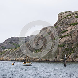 Sailboat at anchor on archipelago coast photo