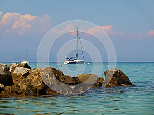 Sailboat anchored in the turquoise waters of The Aegean Sea at Kallithea, Greece