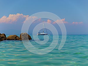 Sailboat anchored in the turquoise waters of The Aegean Sea at Kallithea, Greece