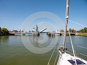 Sailboat approaching bridge - 2 4, Warnsebrug over Johan Frisokanaal, Friesland, Netherlands photo