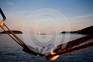 Sailboat in Background with Ropes at Sunset