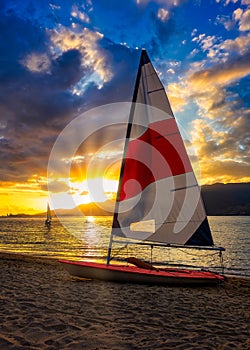 Sailboat on the beach sand at sunset in Ilhabela, Sao Paulo - Brazil