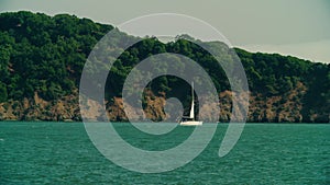 Sailboat bobs past the cliffs of Angel Island in SF Waters. View from Tiburon