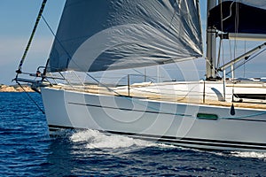 Sailboat bow with hoisted genoa is sailing in the Mediterranean photo