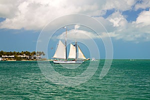 Sailboat on clear blue water of tropical paradise, sailing on holiday island of Sunset Key resort