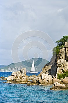 Sailboat in coastal scenery