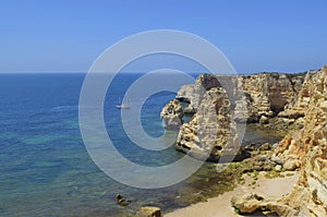 Sailboat on deserted beach and cliffs photo