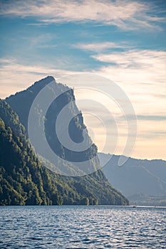 A sailboat in the distance in front of a big mountain