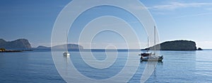 Sailboat docked in front of the beach and the port of Es Canar, Ibiza Island photo