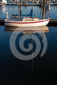 Sailboat docked on still water