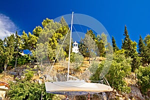 Sailboat on dry dock and stone chapel