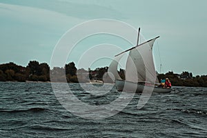 Sailboat floating on water gloomy landscape photo