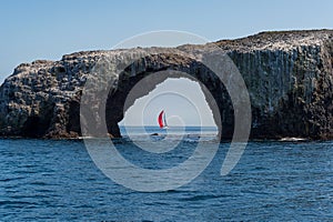 Sailboat framed byArch Rock on Anacapa Island