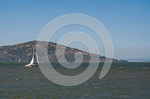 Sailboat in front of island