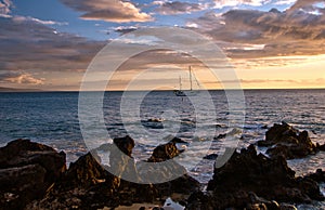 Sailboat and Hawaiian sunset on island of Maui