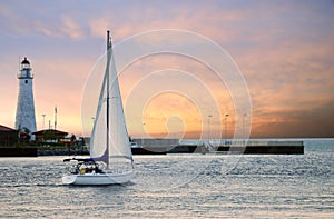 Sailboat leaving marina