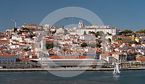 Sailboat on Lisboa Tagus River, waterfront and cityscape. Vacation, leisure, travel concept.