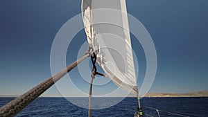 Sailboat Mast and Sail. Open, unfurled sails on a yacht. Sailing in the wind. Full sails, very strong wind.