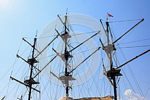 Sailboat masts against the blue sky. Symbol of adventure. Background with copy space