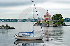 Sailboat Moored Near Lighthouse in Providence Rhode Island photo