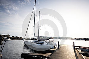 Sailboat moored to a pier in the harbor at sunset Nessebar, Bulgaria