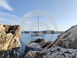 Sailboat mooring in a small cove of beach Velo Zarace on Hvar island, Croatia in sunset photo