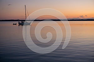 Sailboat Motoring at Sunset on Chesapeake Bay