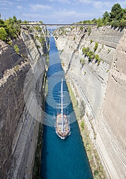 Sailboat navigating the narrow Canal of Corinth, in Greece.