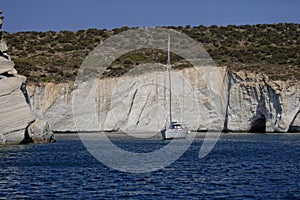 Sailboat near Milos cliffs