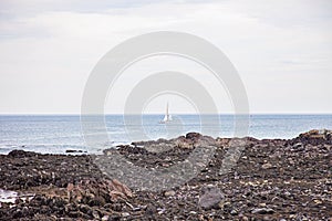 Sailboat near Oarweed Cove along the rocky coast of Maine in Ogunquit