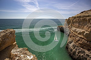 Sailboat near Three Castles beach in Portimao, District Faro, Algarve, Southern Portugal. Landscape, region