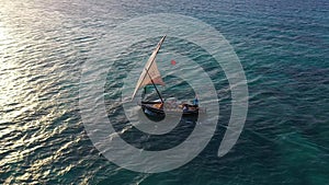 Sailboat in the ocean. Sunset. Drone view of the african traditional wooden boats. Sailing yachts moored off the coast