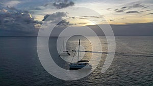 Sailboat in the ocean. Sunset. Drone view of the african traditional wooden boats. Sailing yachts moored off the coast