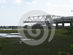 Sailboat passing through ben sawyer bridge in Charleston South Carolina