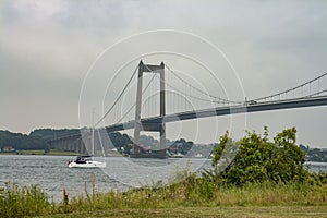 Sailboat Passing a Bridge