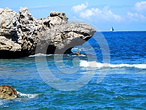 Sailboat passing a Caribbean Island