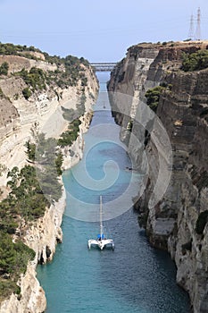 Sailboat passing through Corinth Canal