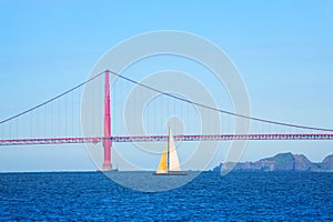 Sailboat passing under the Golden Gate Bridge, USA