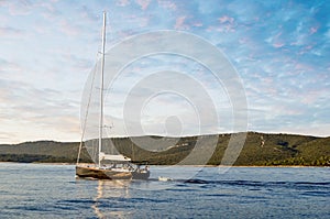 Sailboat in the plain sea sailing between the Lavezzi islands