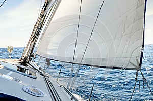 Sailboat in the plain sea sailing between the Lavezzi islands