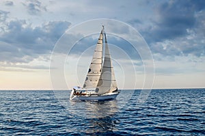 Sailboat in the plain sea sailing between the Lavezzi islands