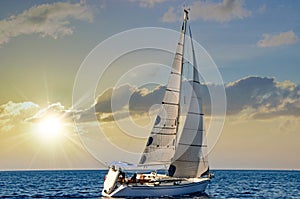 Sailboat in the plain sea sailing between the Lavezzi islands