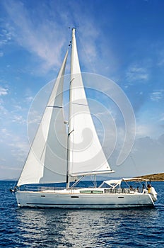 Sailboat in the plain sea sailing between the Lavezzi islands