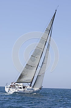 Sailboat Racing In The Blue Ocean Against Sky