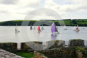 Sailboat racing past Charles Fort