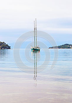 Sailboat reflected on sea at Porto Heli beach Argolis Greece