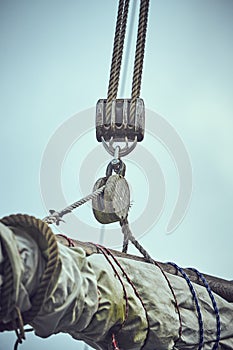 Sailboat ropes wooden pulley rigs. Part of a sail boat. Close-up view of sailboat ropes, pulleys and ropes on the mast, Yachting s